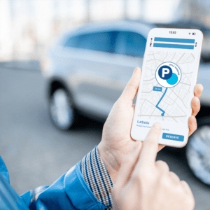 Man holding phone making parking reservation on app